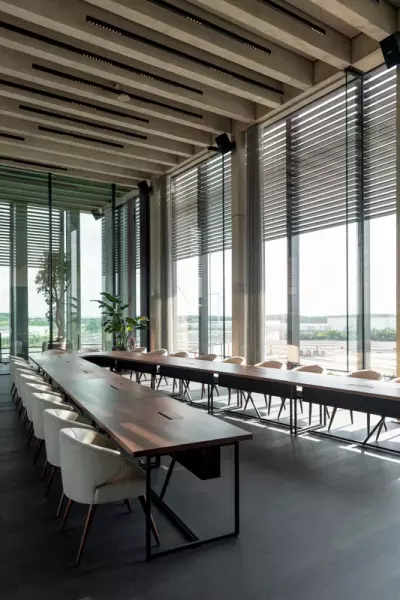 Large v-shaped wooden conference table with modern conference chairs
